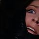 A black-gloved hand moves to cover a terrified woman's face in a scene from 1970's The Bird With the Crystal Plumage.
